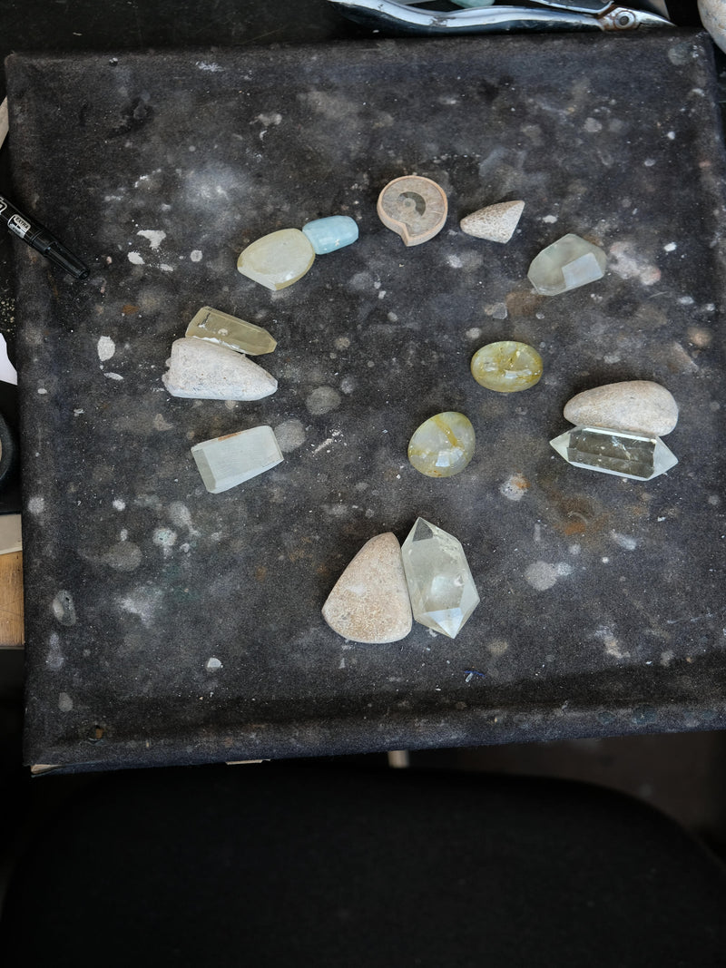 Collection of assorted stones and fossils on a dark surface