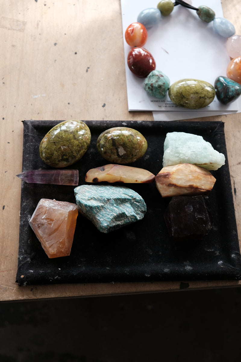 Natural stones in different colors displayed in a workshop environment
