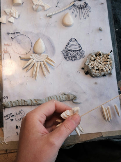 Earrings: bone, cone shell