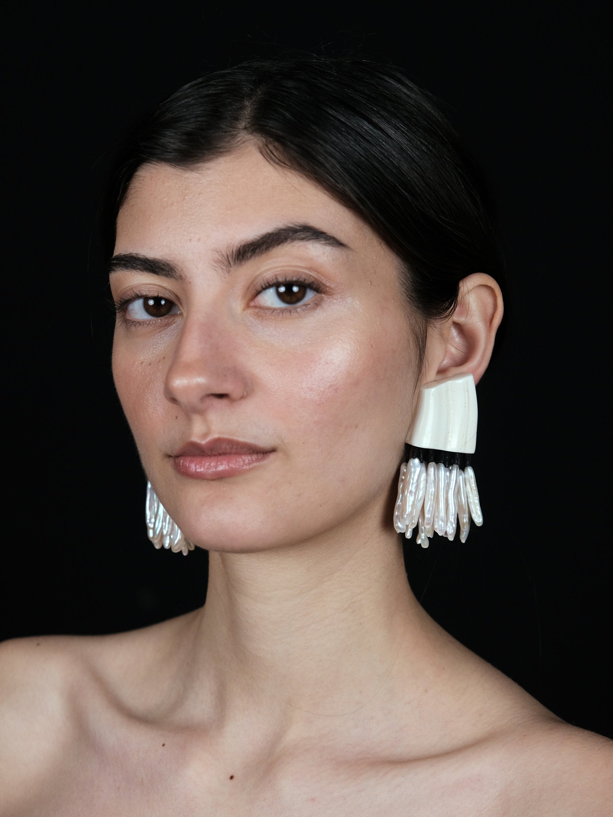 Earrings: freshwater pearls, warthog bone