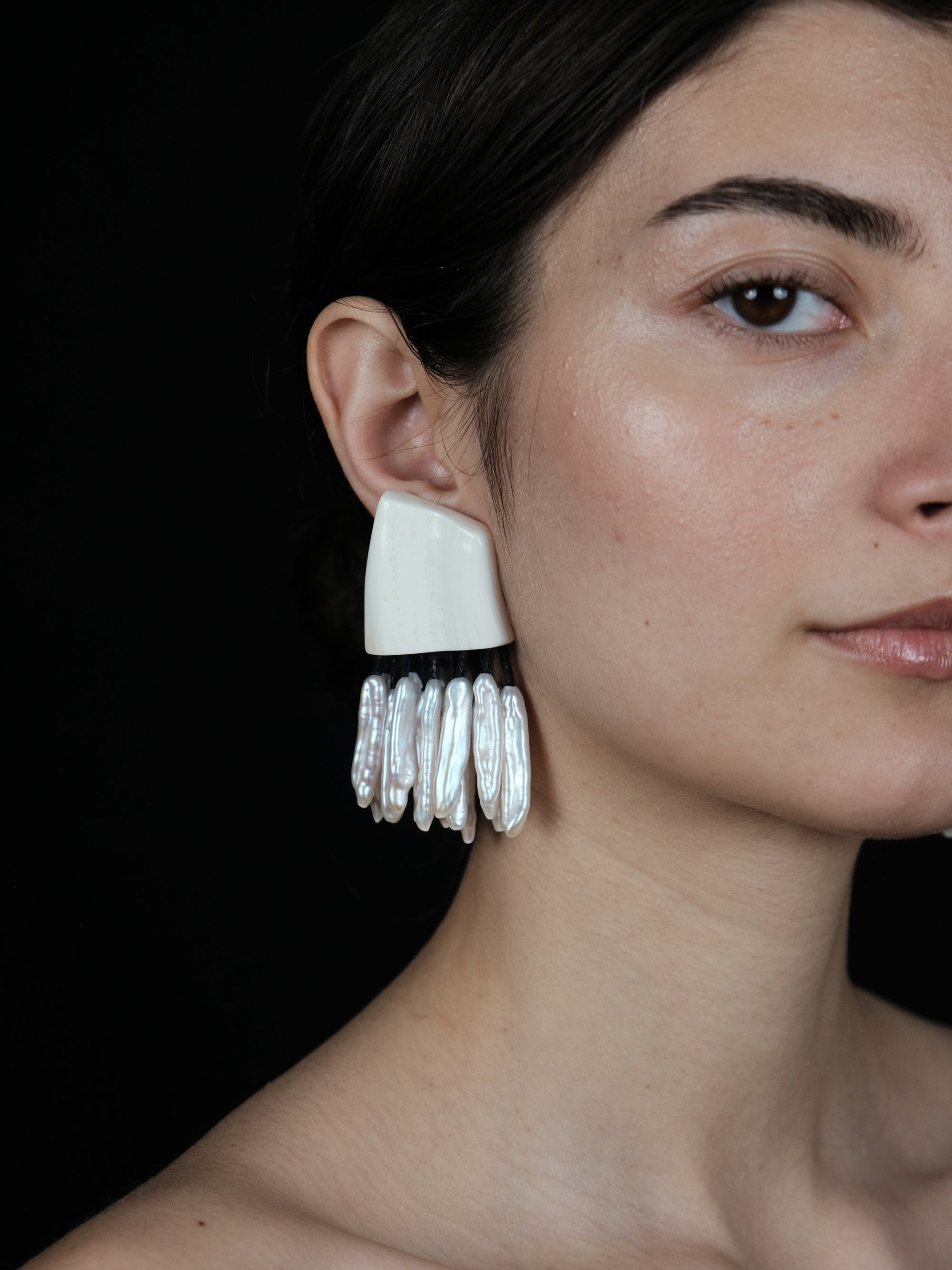 Earrings: freshwater pearls, warthog bone