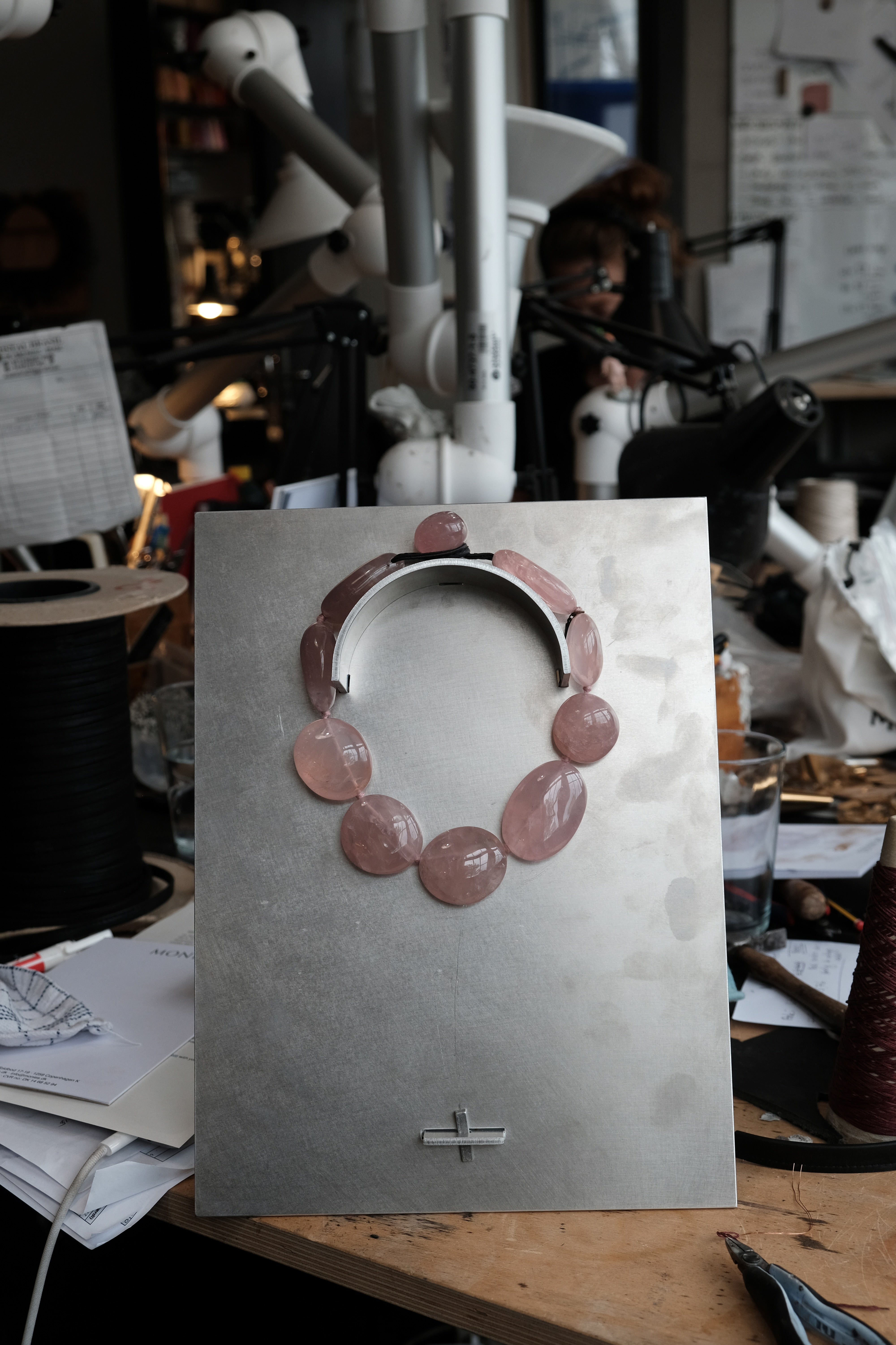 Rose quartz necklace on steel plate