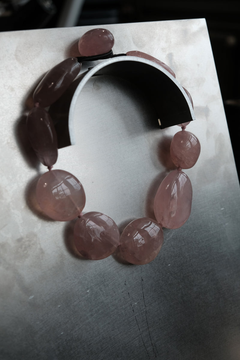 Rose quartz necklace on steel plate