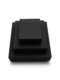 Set of black jewelry boxes with 'MONIES' branding on a white background