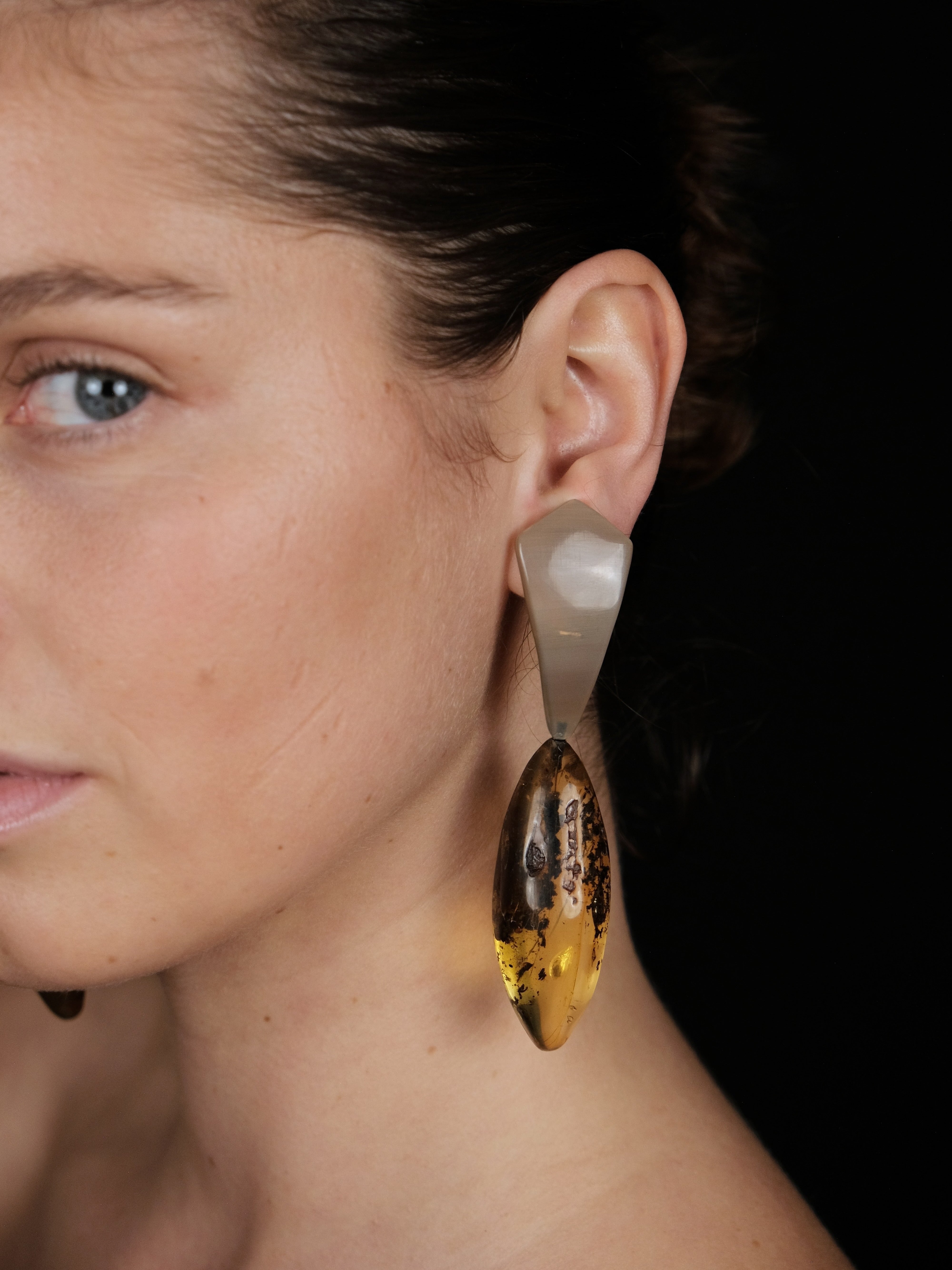 Earrings: horn, amber