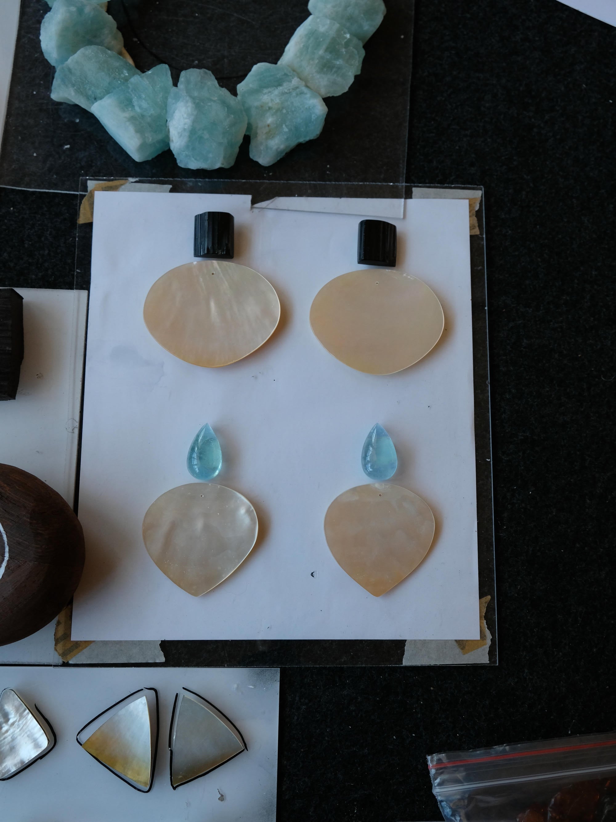 Set of stone-like objects on a white card with a dark background
