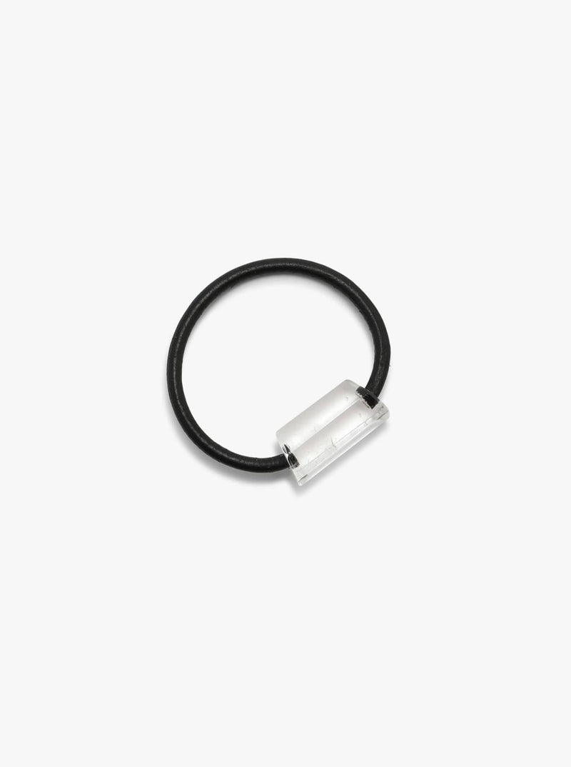 Black leather bracelet with a mountain crystal on a white background.