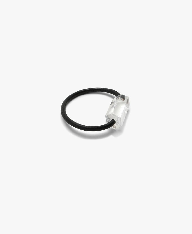 Black leather bracelet with a mountain crystal on a white background.