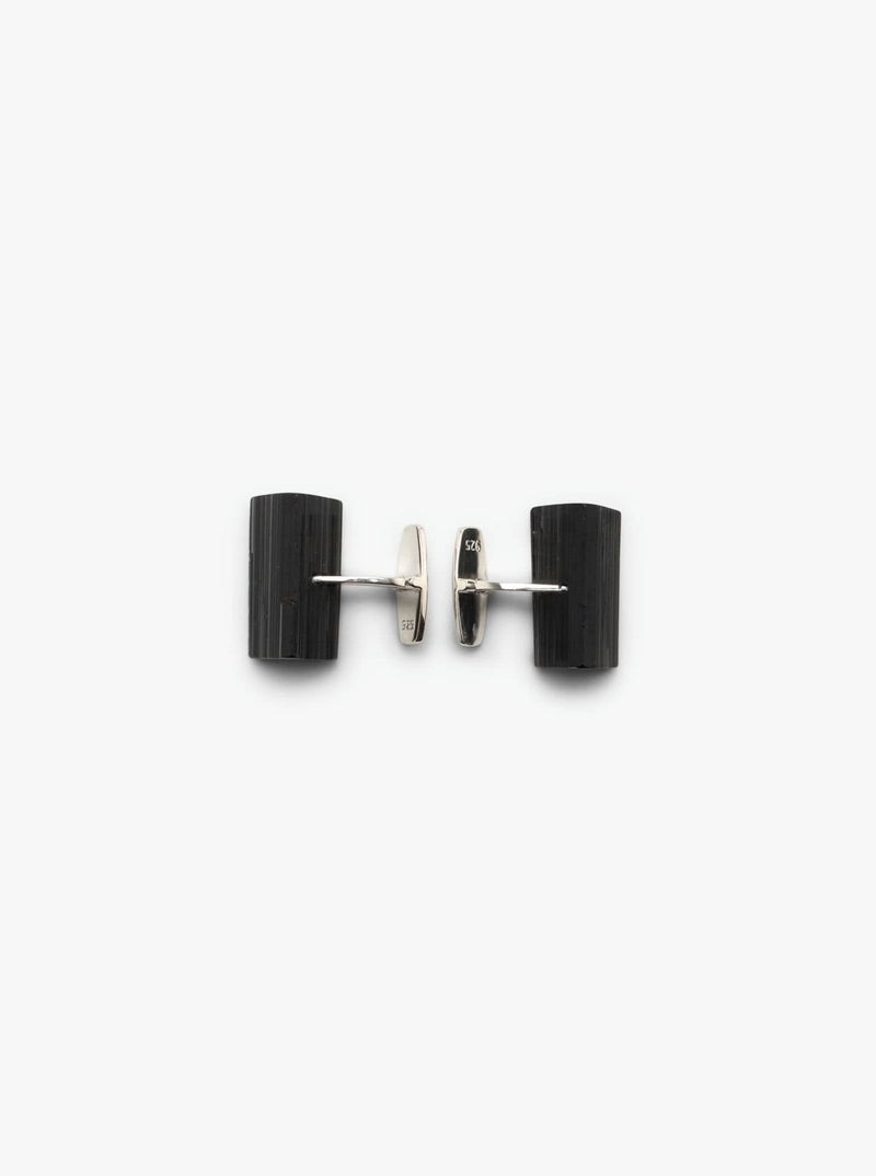 A pair of black tourmaline cuff links with sterling silver mounting, photographed on a white background.