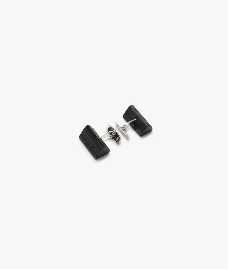 A pair of black tourmaline cuff links with sterling silver mounting, photographed on a white background.