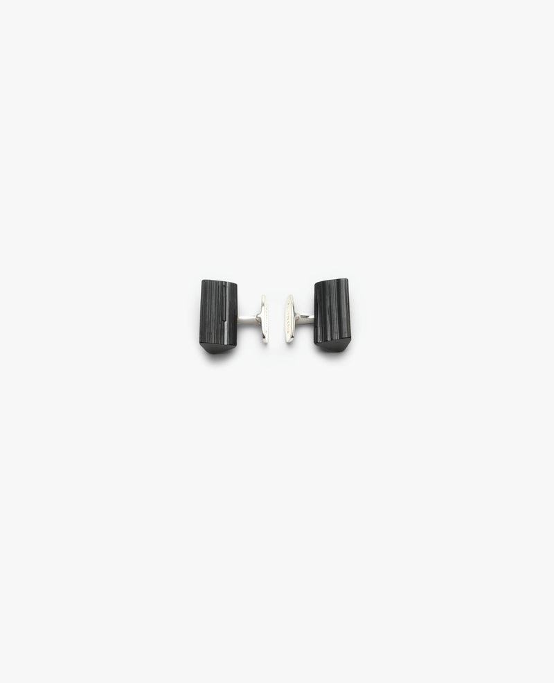 A pair of black tourmaline cuff links with sterling silver mounting, photographed on a white background.