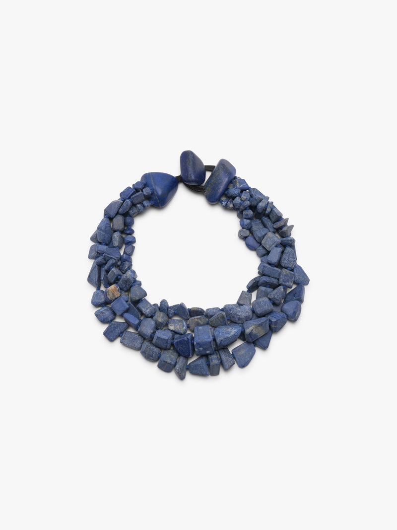 Multistrand blue stone necklace on a white background