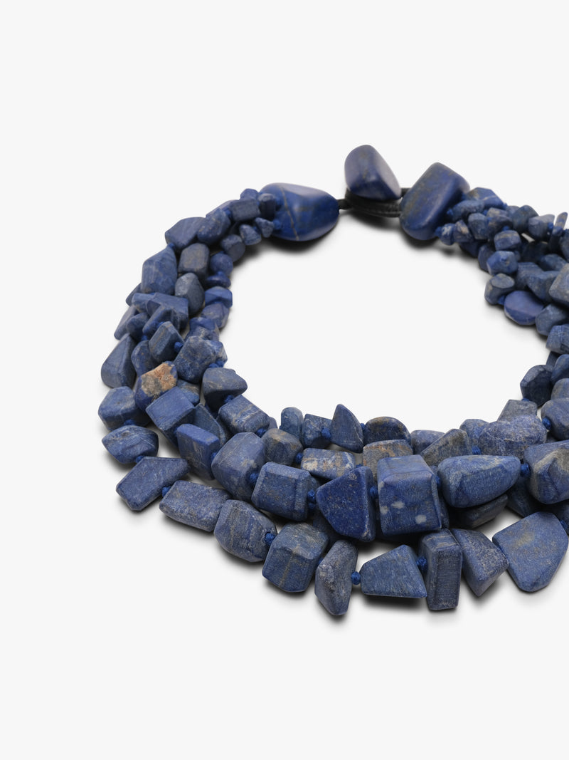 Multistrand blue stone necklace on a white background