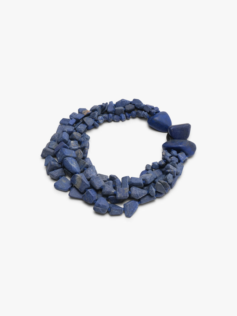 Multistrand blue stone necklace on a white background