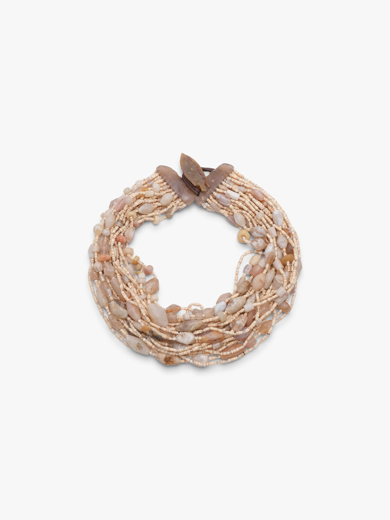 Multistrand beaded necklace with a brown and beige beads on a brown leather strap on a white background