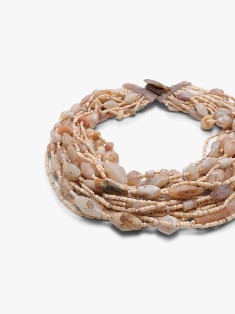 Multistrand beaded necklace with a brown and beige beads on a brown leather strap on a white background