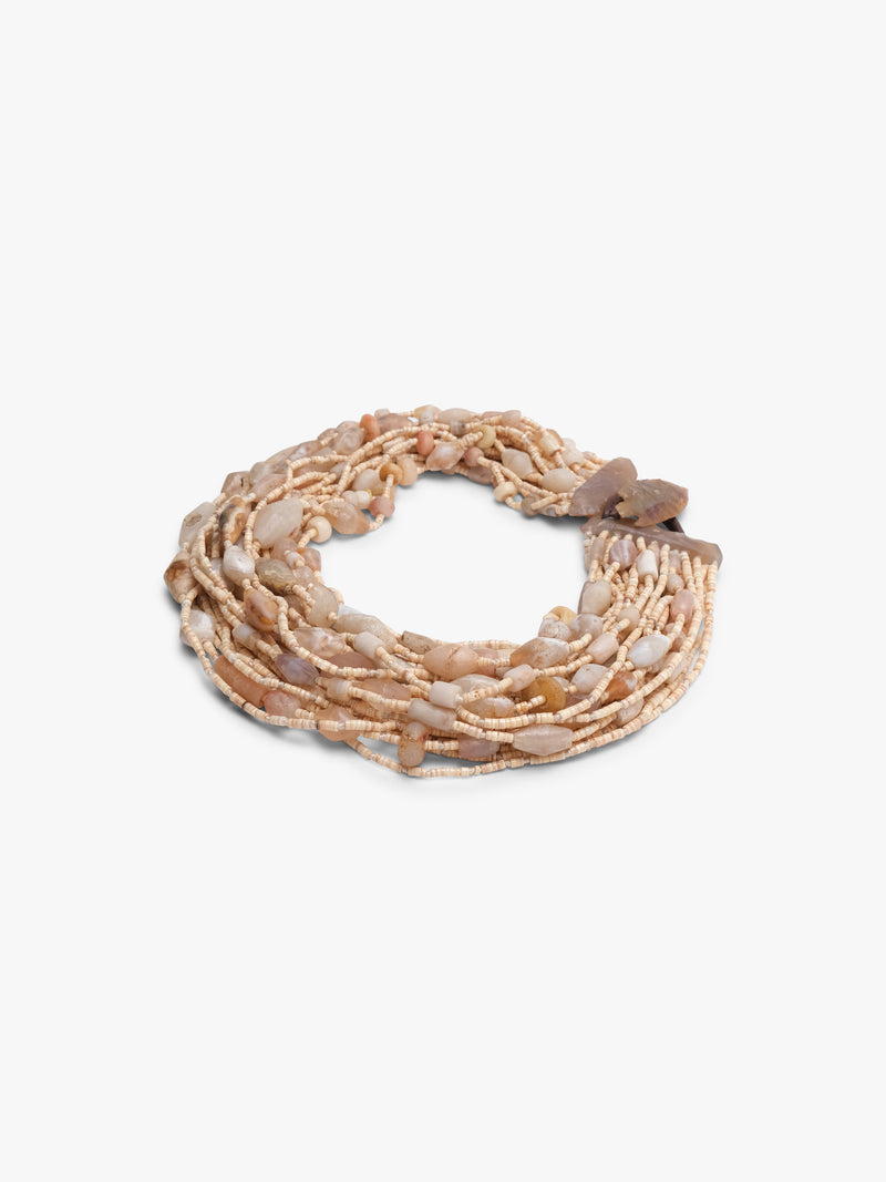 Multistrand beaded necklace with a brown and beige beads on a brown leather strap on a white background