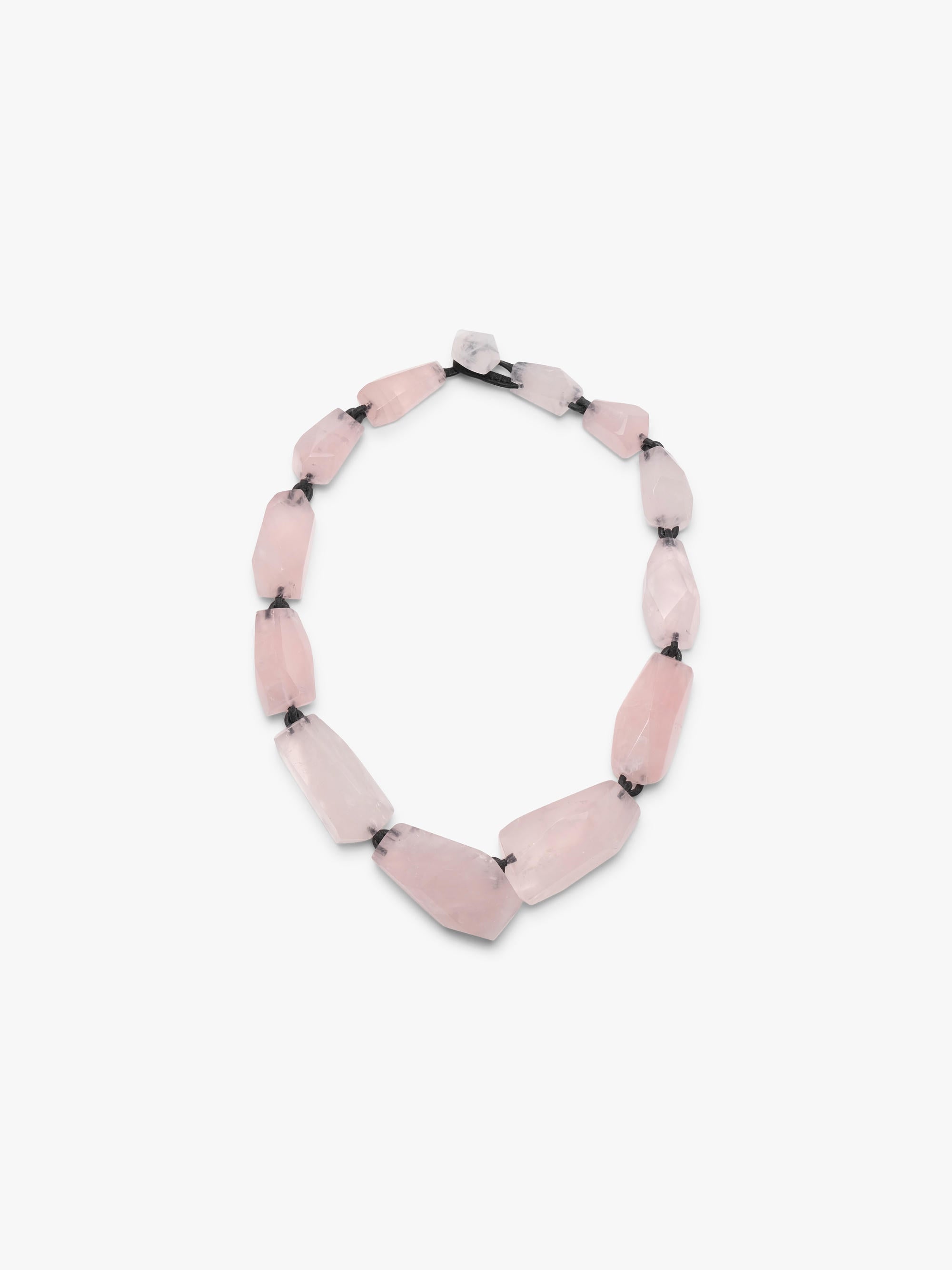 Necklace with pink rose quartz on a white background