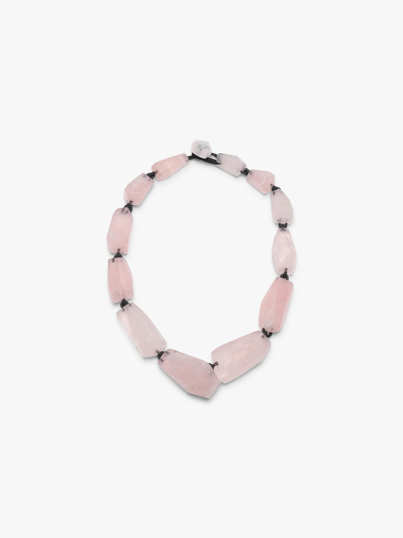 Necklace with pink rose quartz on a white background