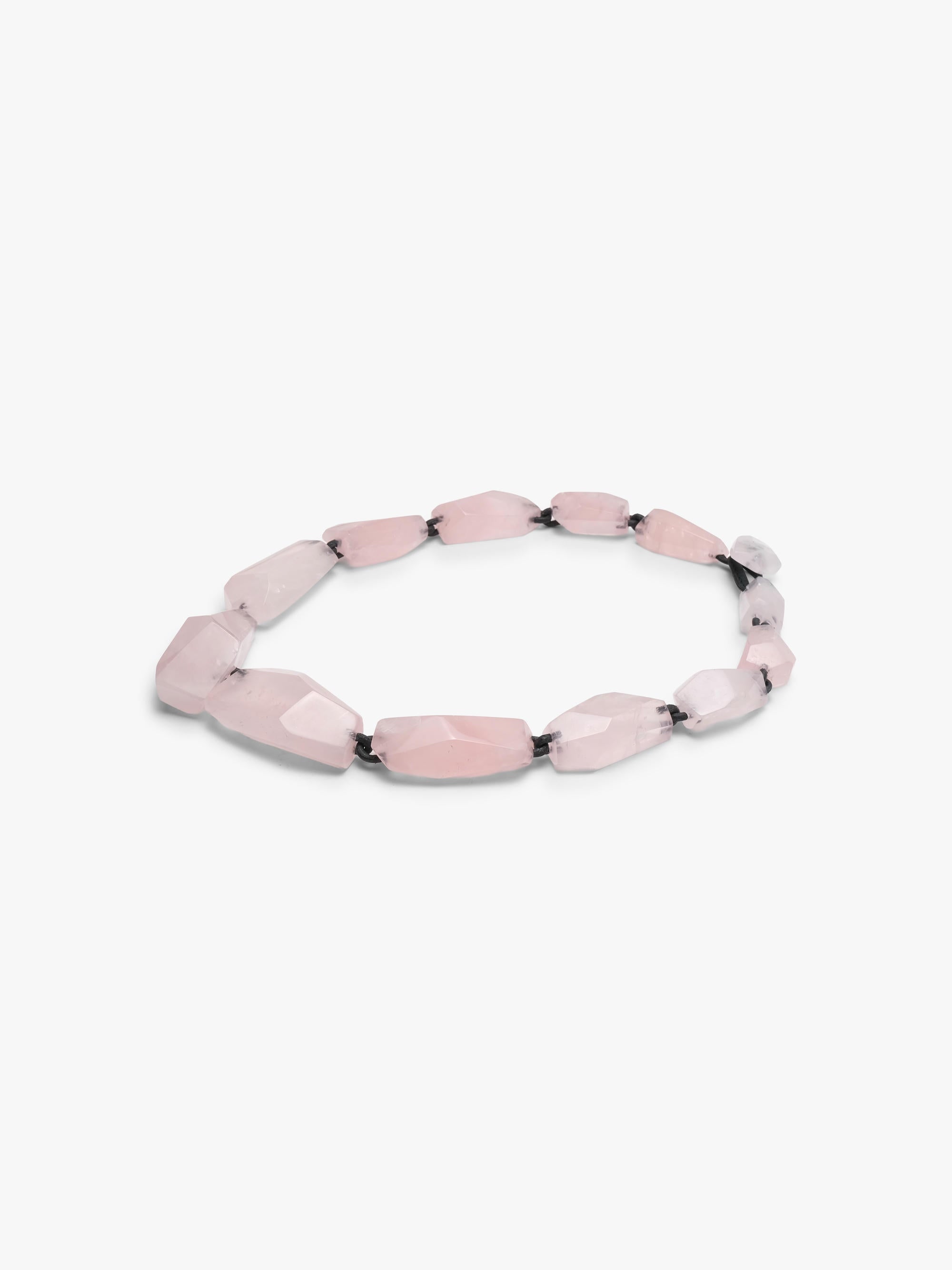 Necklace with pink rose quartz on a white background