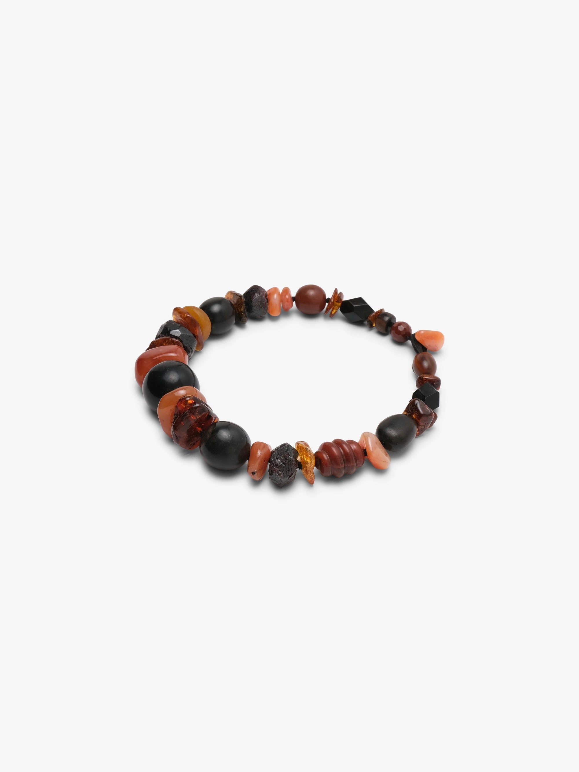 necklace of orange and black stones on white background