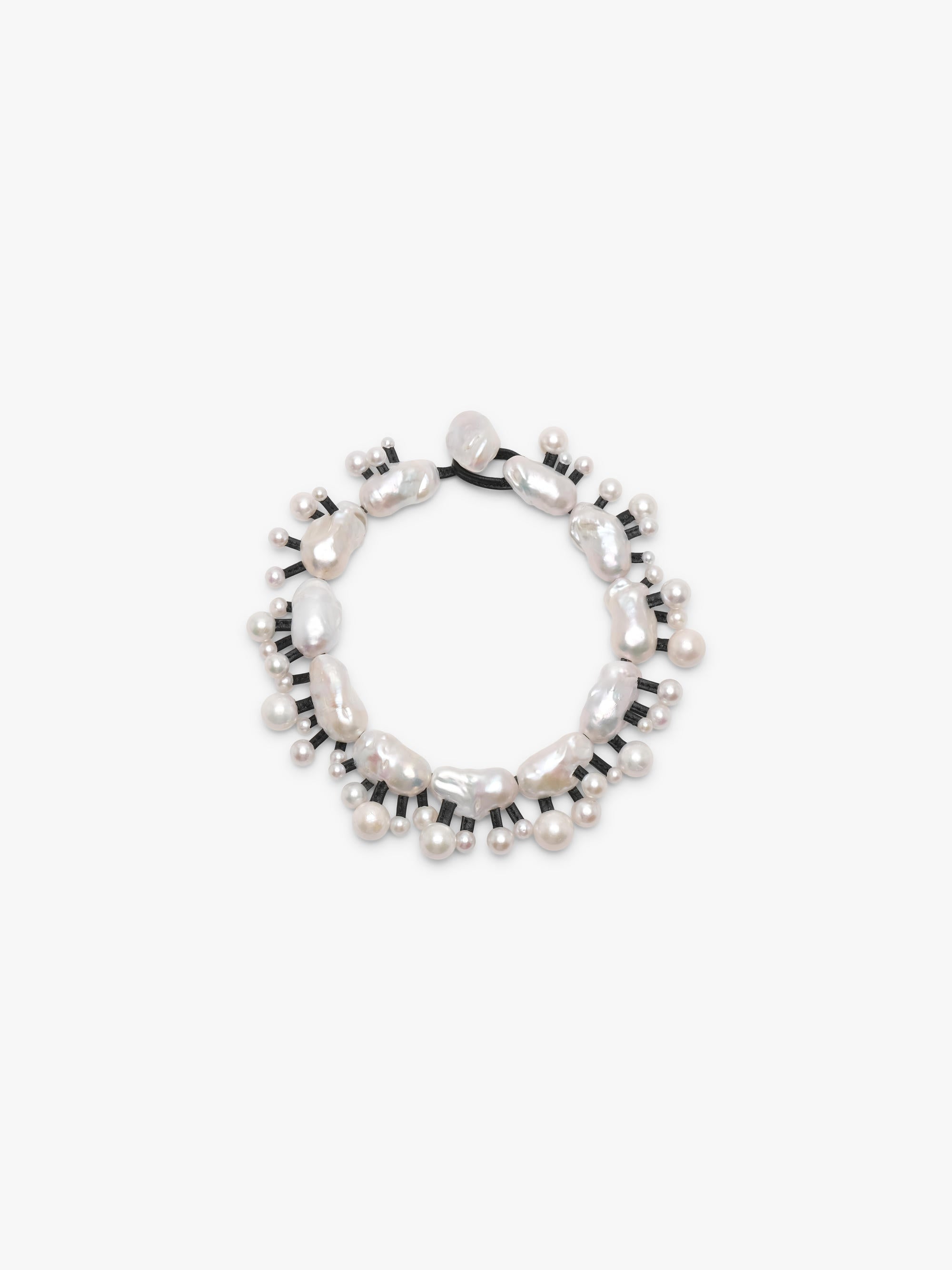 Silver necklace with baroque and freshwater pearls on a white background