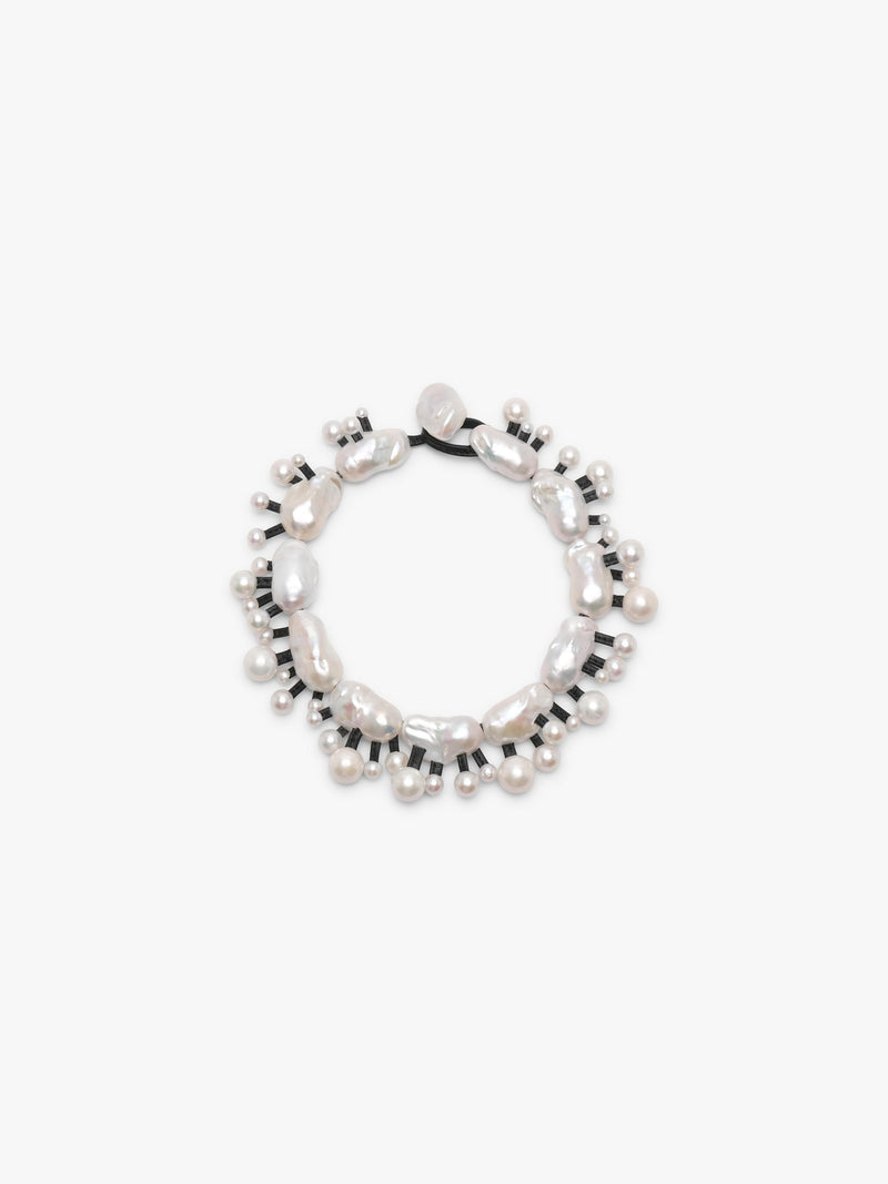 Silver necklace with baroque and freshwater pearls on a white background