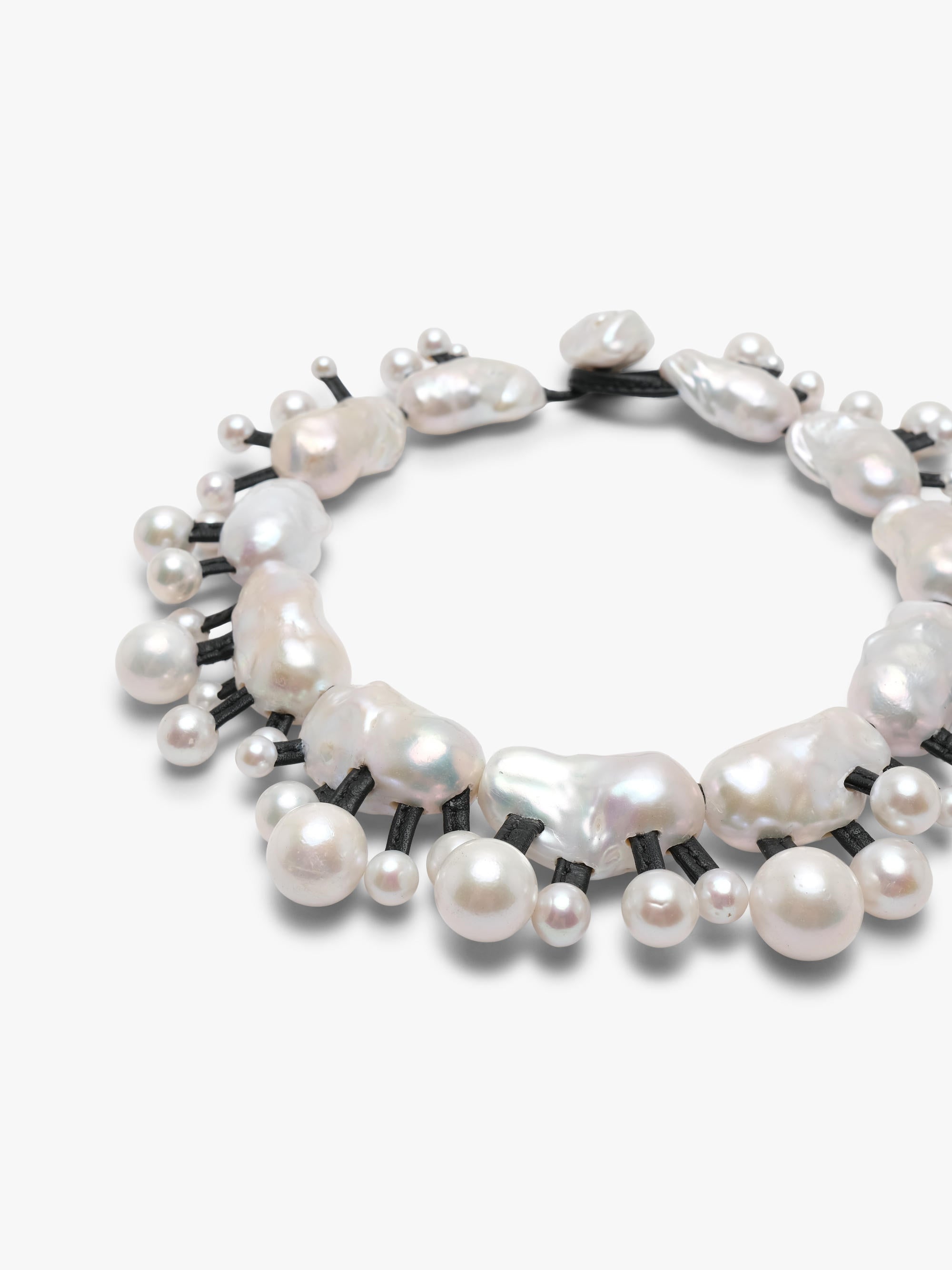 Silver necklace with baroque and freshwater pearls on a white background