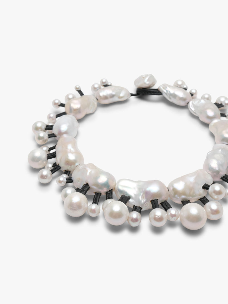 Silver necklace with baroque and freshwater pearls on a white background