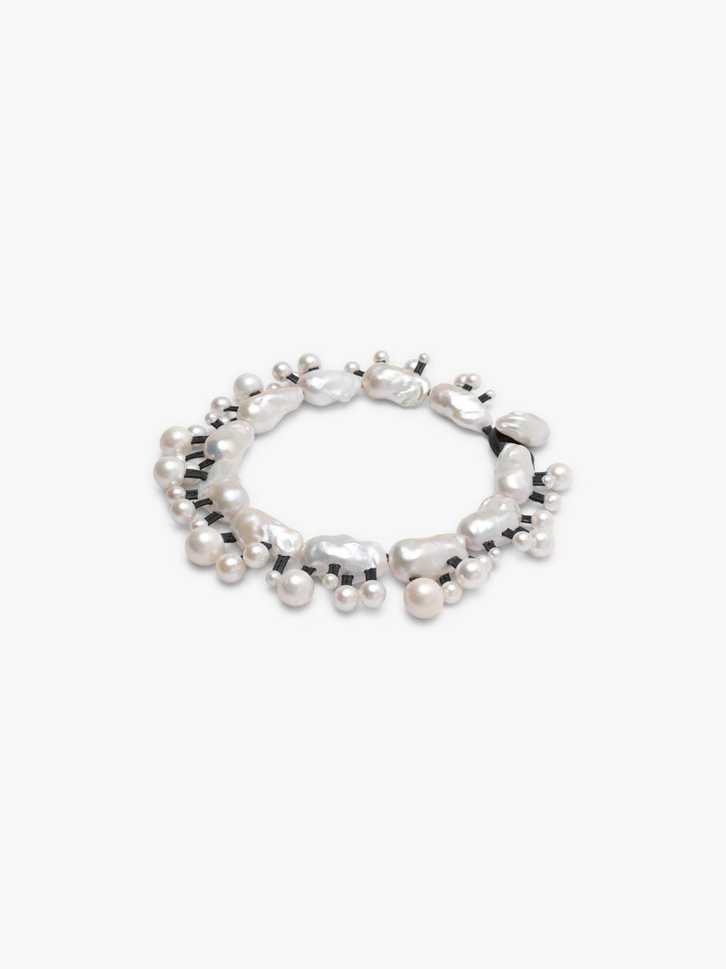 Silver necklace with baroque and freshwater pearls on a white background