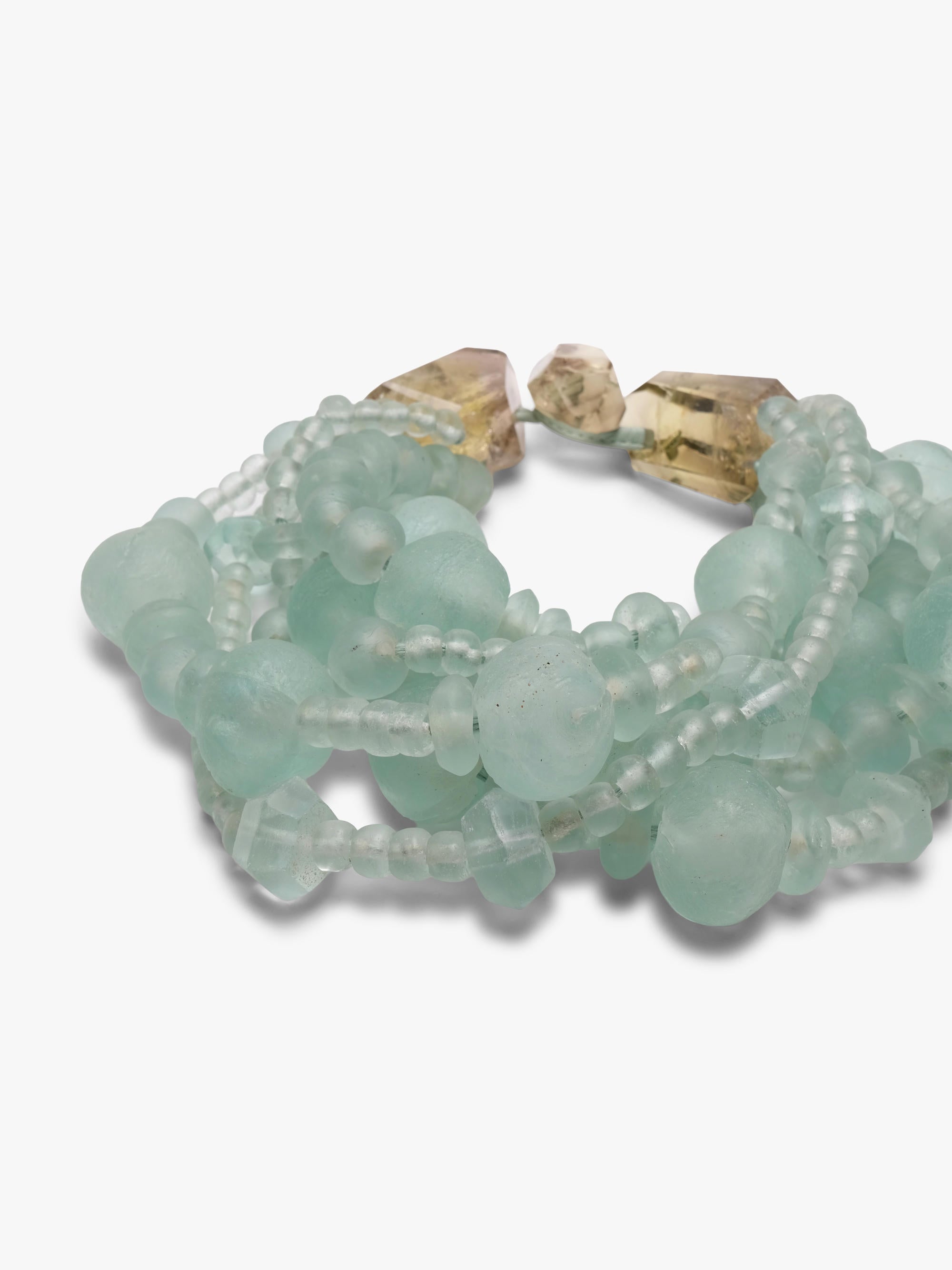 multistrand necklace with green glass beads and citrine closure.