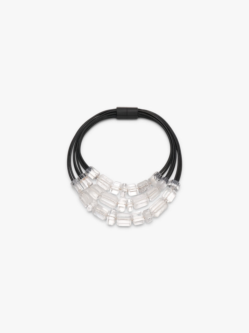 Necklace with black cord and clear mountain crystal beads on a white background