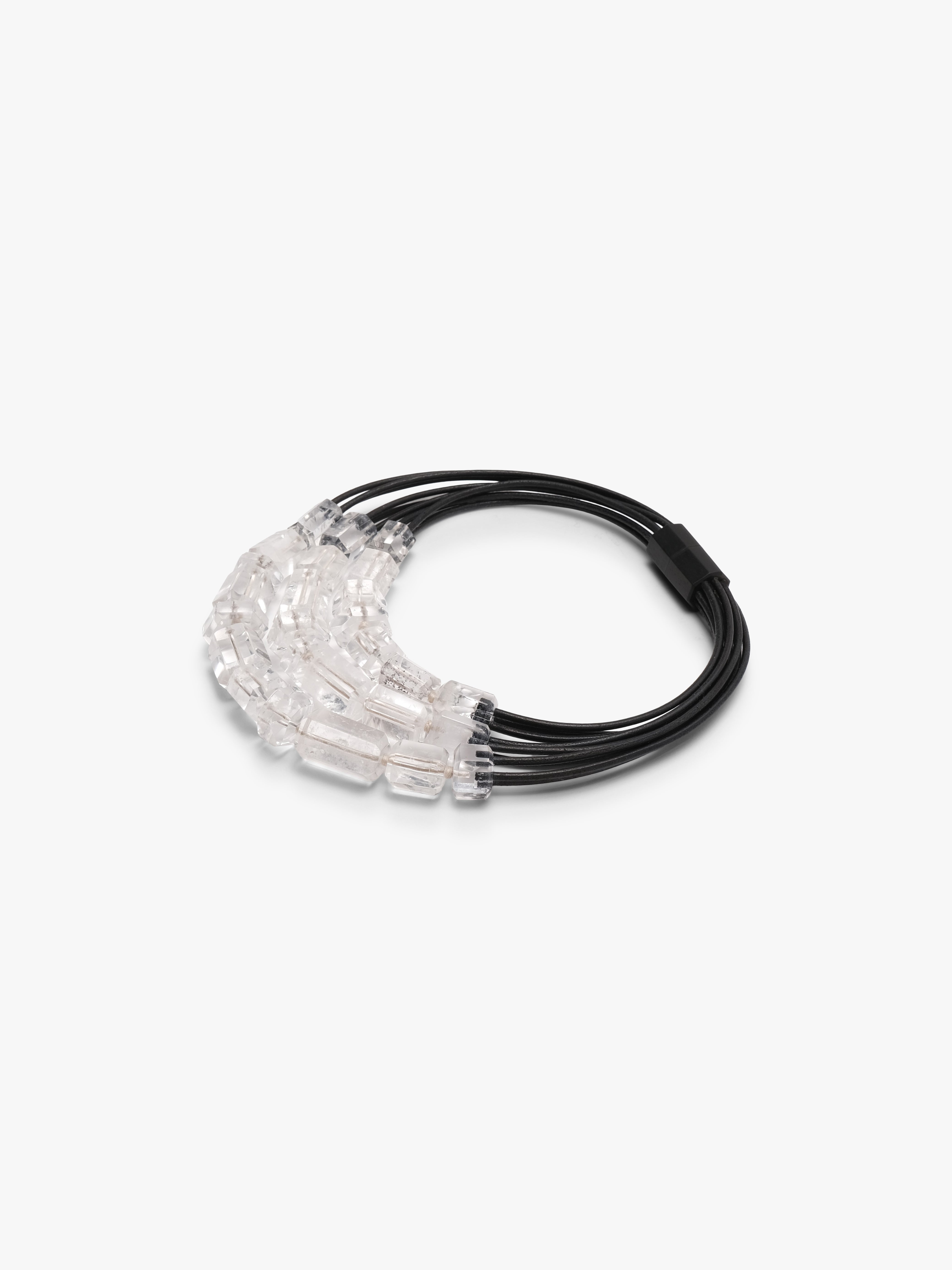 Necklace with black cord and clear mountain crystal beads on a white background