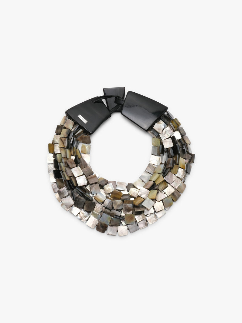 A multi-strand statement necklace featuring polished metallic square beads in silver, bronze, and gold tones, accented by two large dark brown shell-like end caps, shown on a plain light gray background.