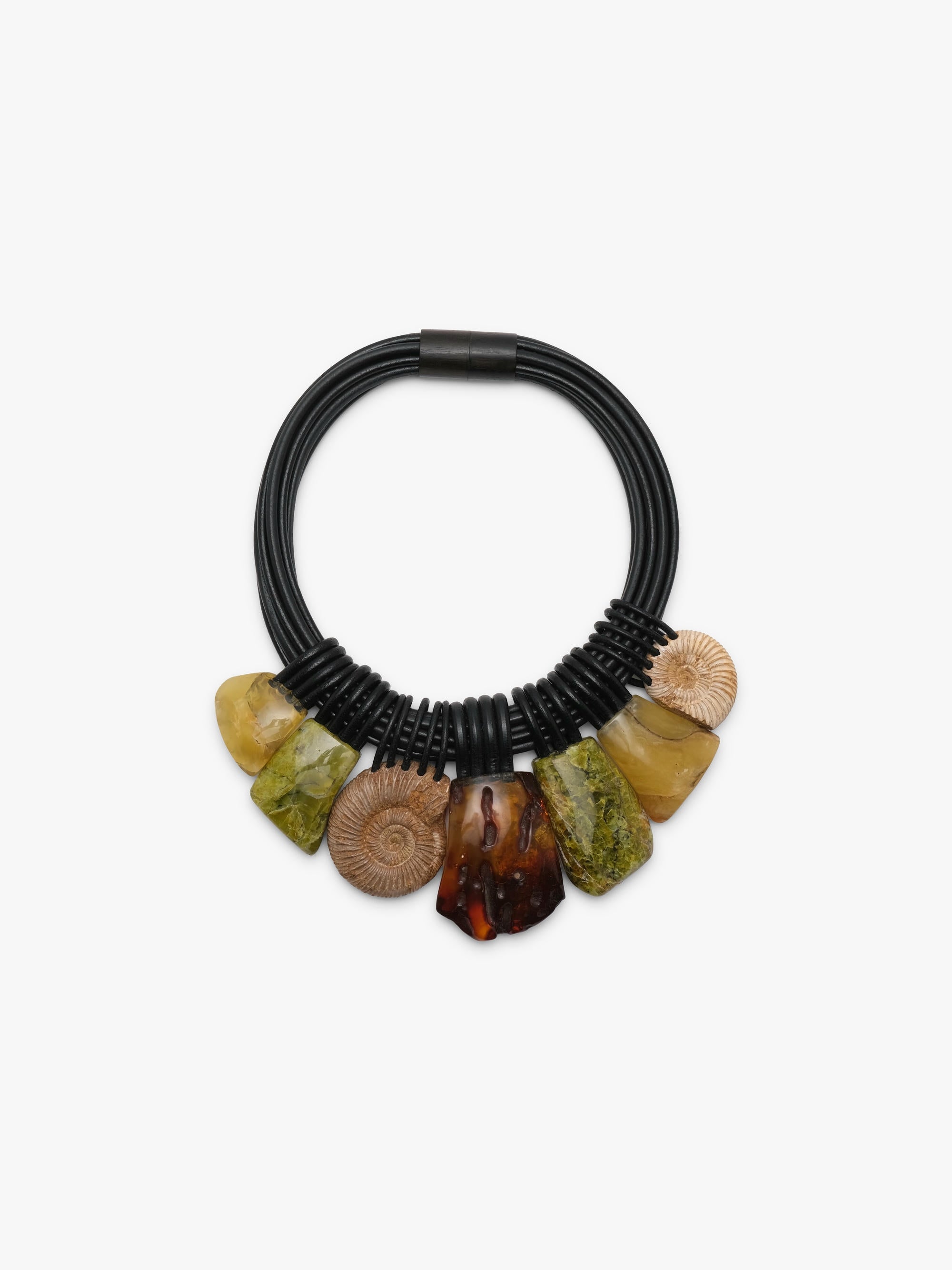 A close up of a black leather necklace, with natural stone beads in brown, green and yellow colours, displayed on a white background.