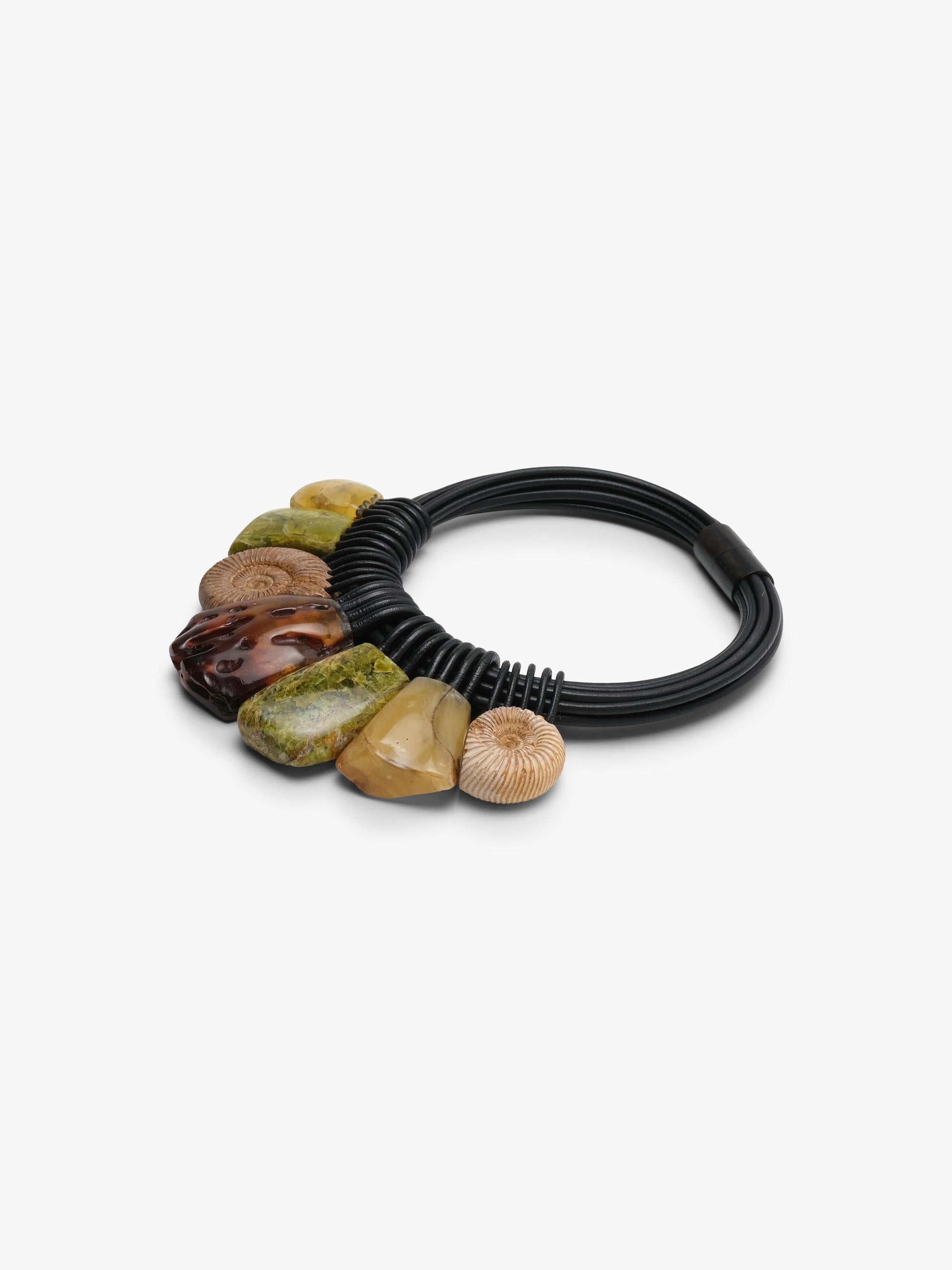 A close up of a black leather necklace, with natural stone beads in brown, green and yellow colours, displayed on a white background.