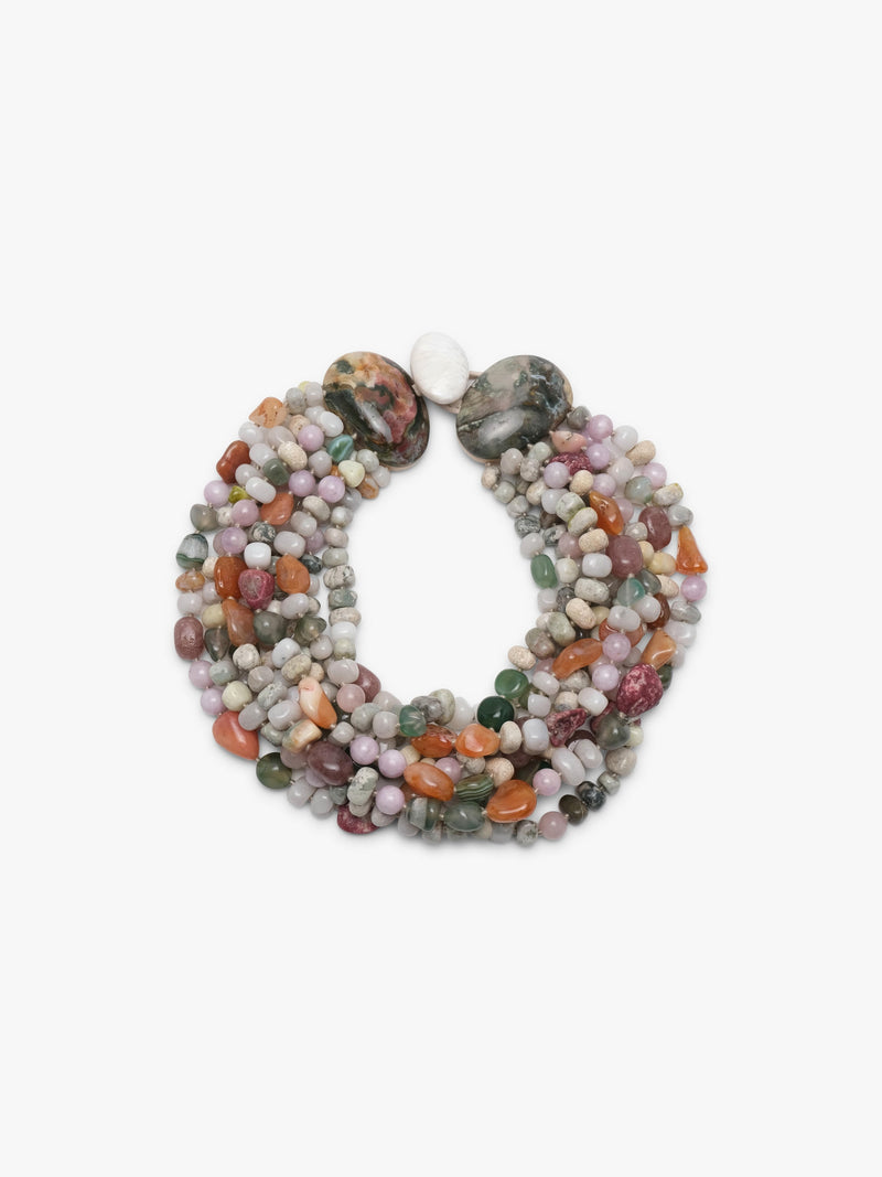 A multi-strand beaded necklace made of polished gemstone chips in various colors including pink, green, orange, gray, and white, arranged in a circular shape on a plain white background.