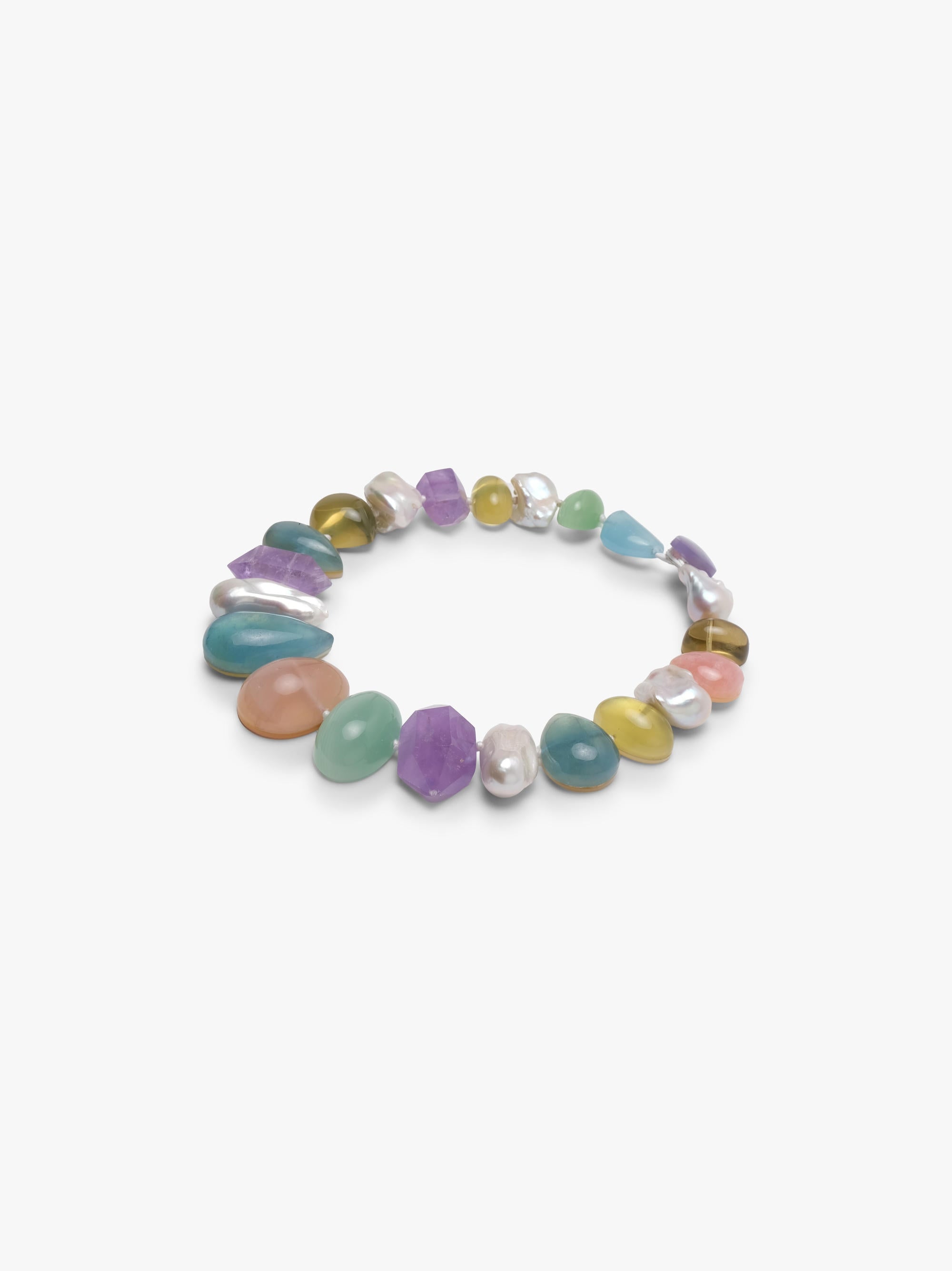 A single strand colorful necklace with green, blue, yellow beads and baroque pearls. Arranged on a white background. 