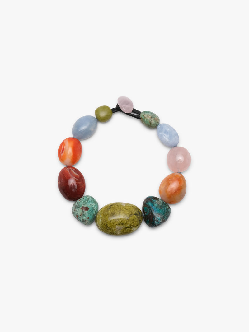 A beaded necklace made of polished, multi-colored gemstone beads on a black elastic band, photographed against a clean white background.