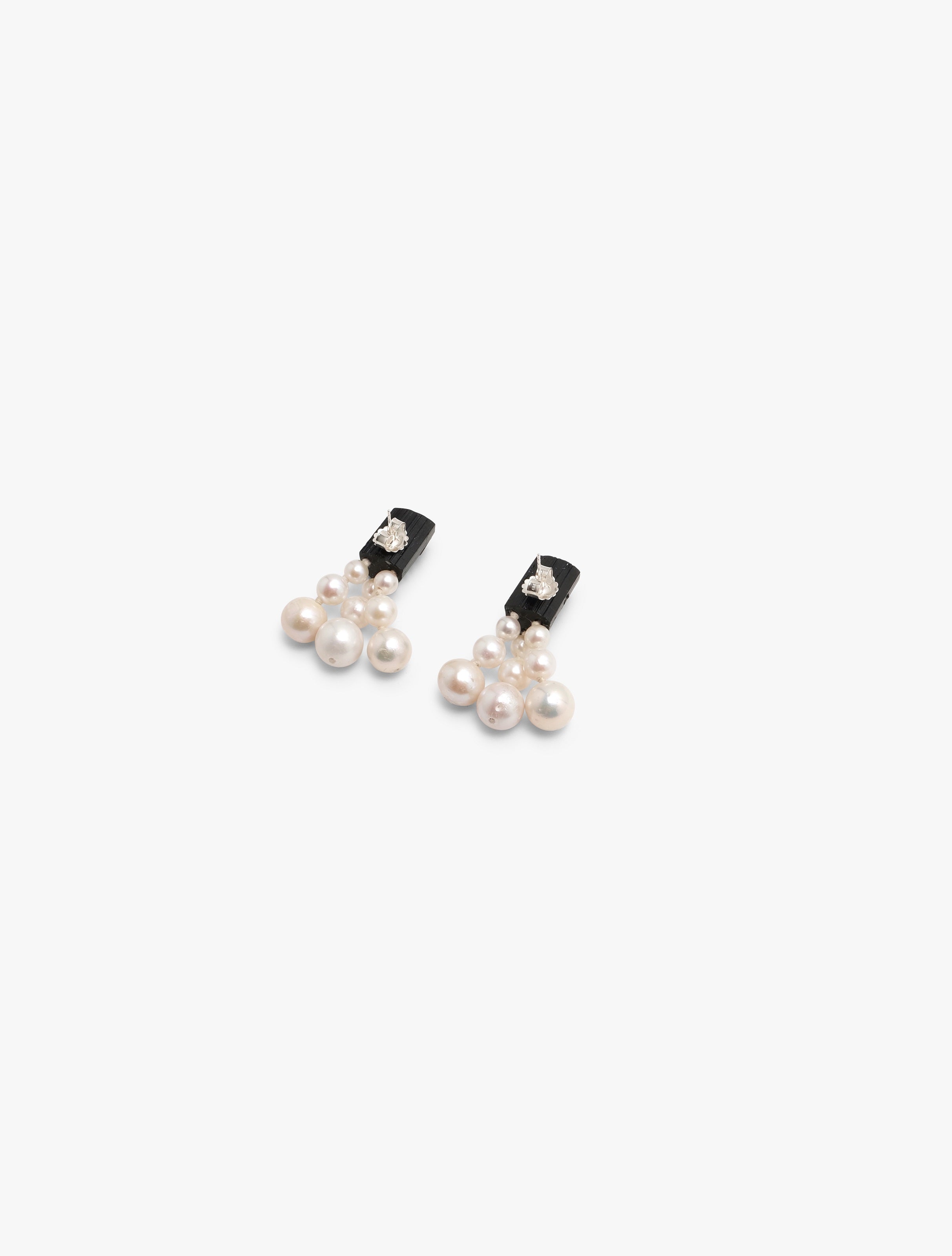 black earrings with a cluster of pearls underneath, displayed on a white background