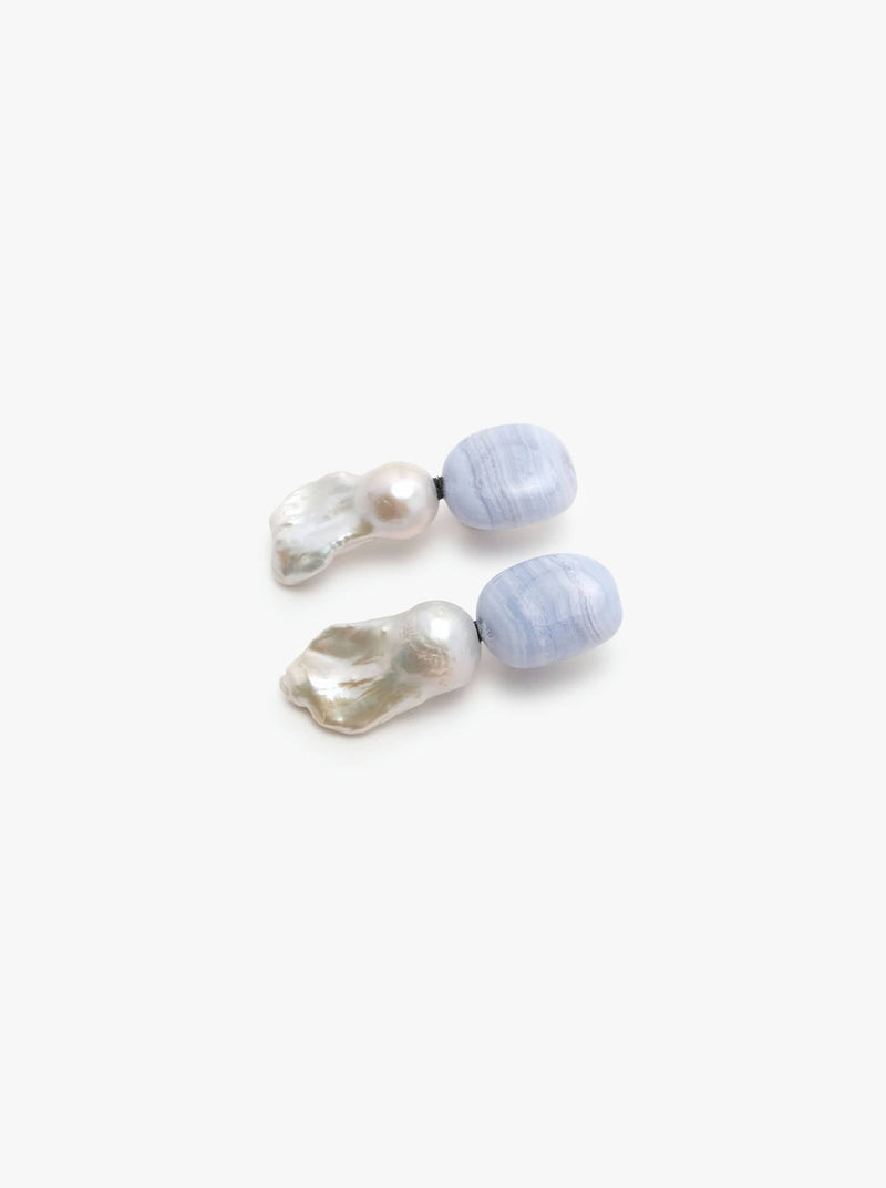 Dangle earrings in blue agate and baroque pearls. Displayed on a white backgorund