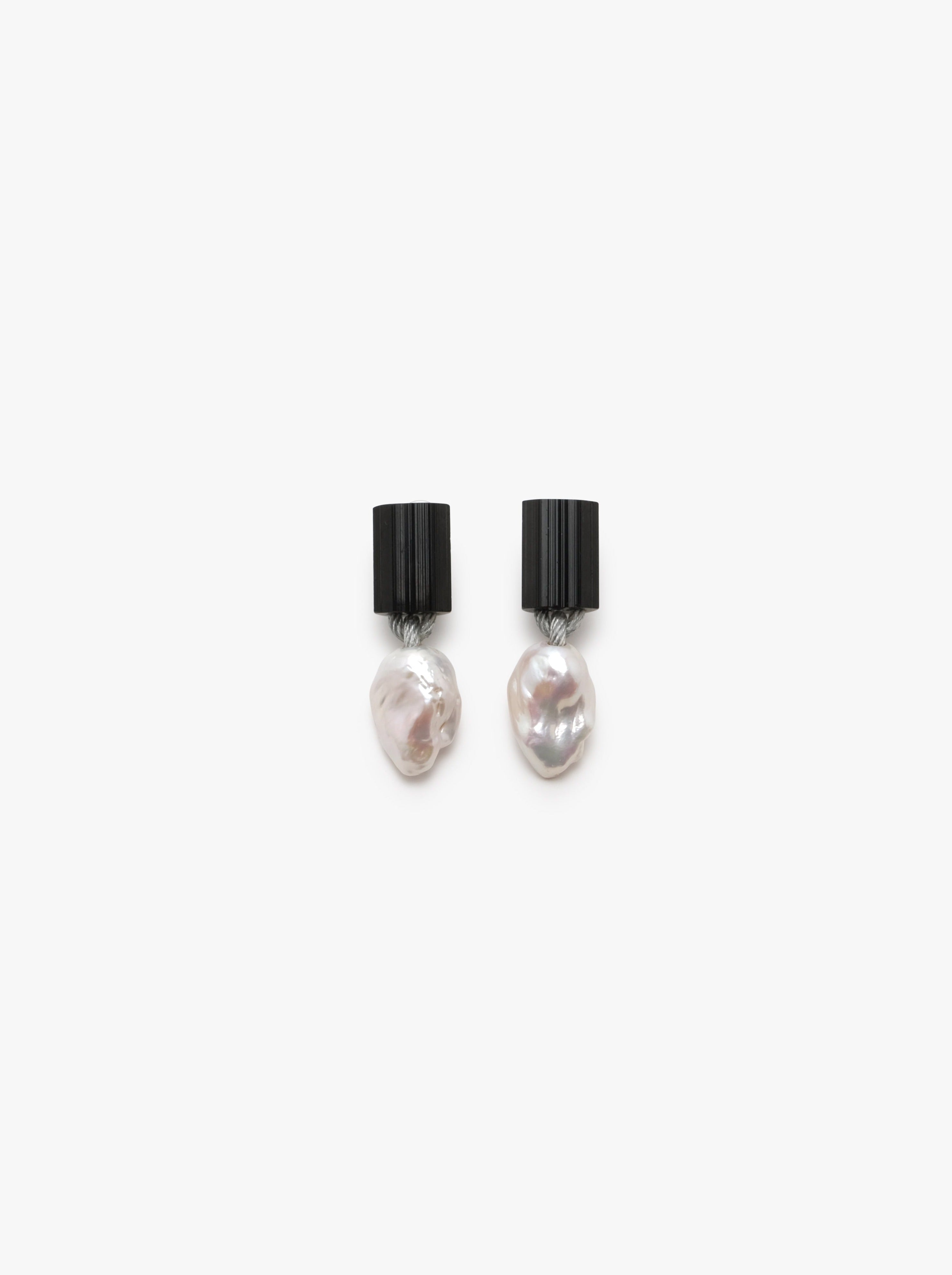 black earrings with baroque pearl extended beneath, displayed on a white background