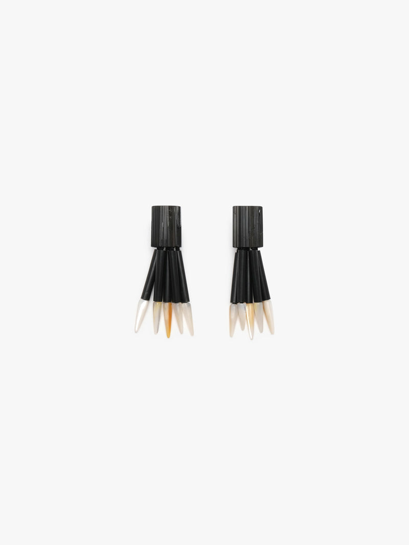 Black dangle earrings with white spears on a white background