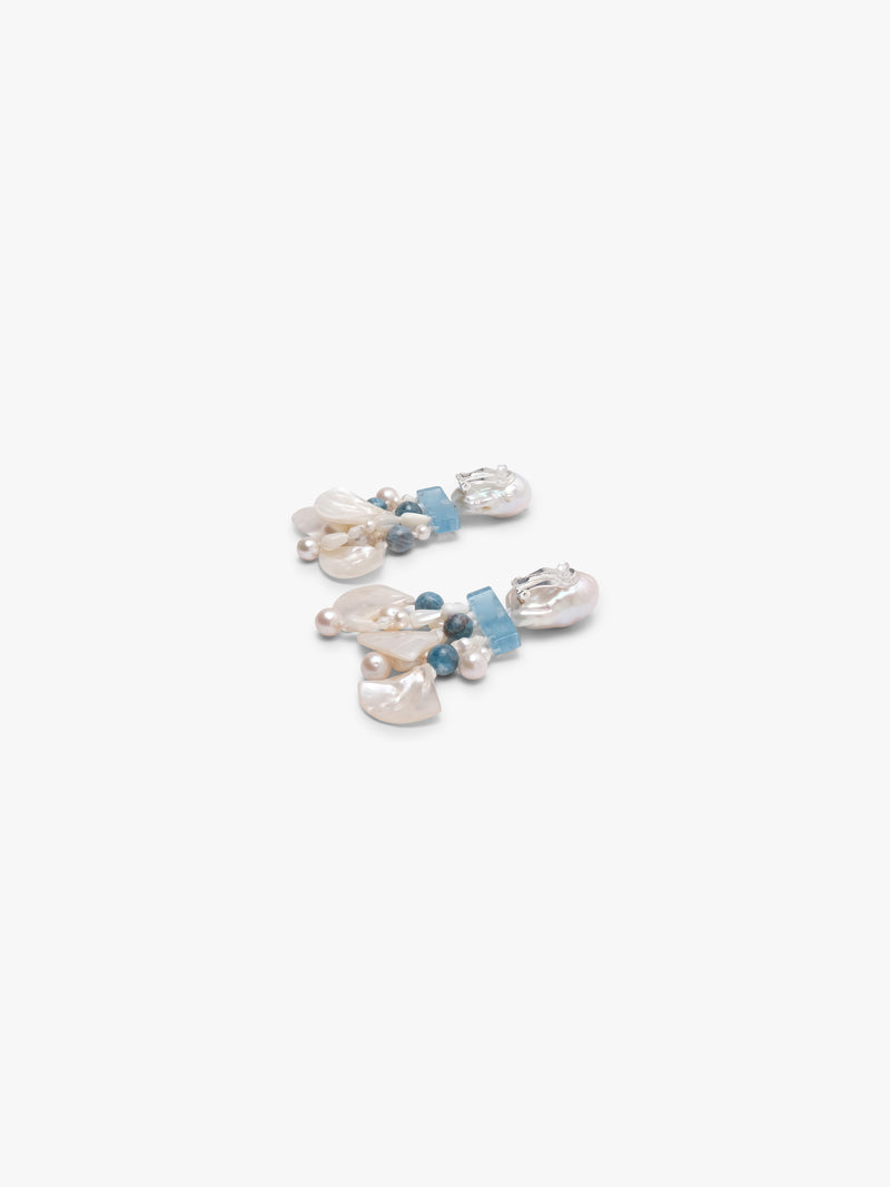Pair of earrings with pearls and blue stones on a white background