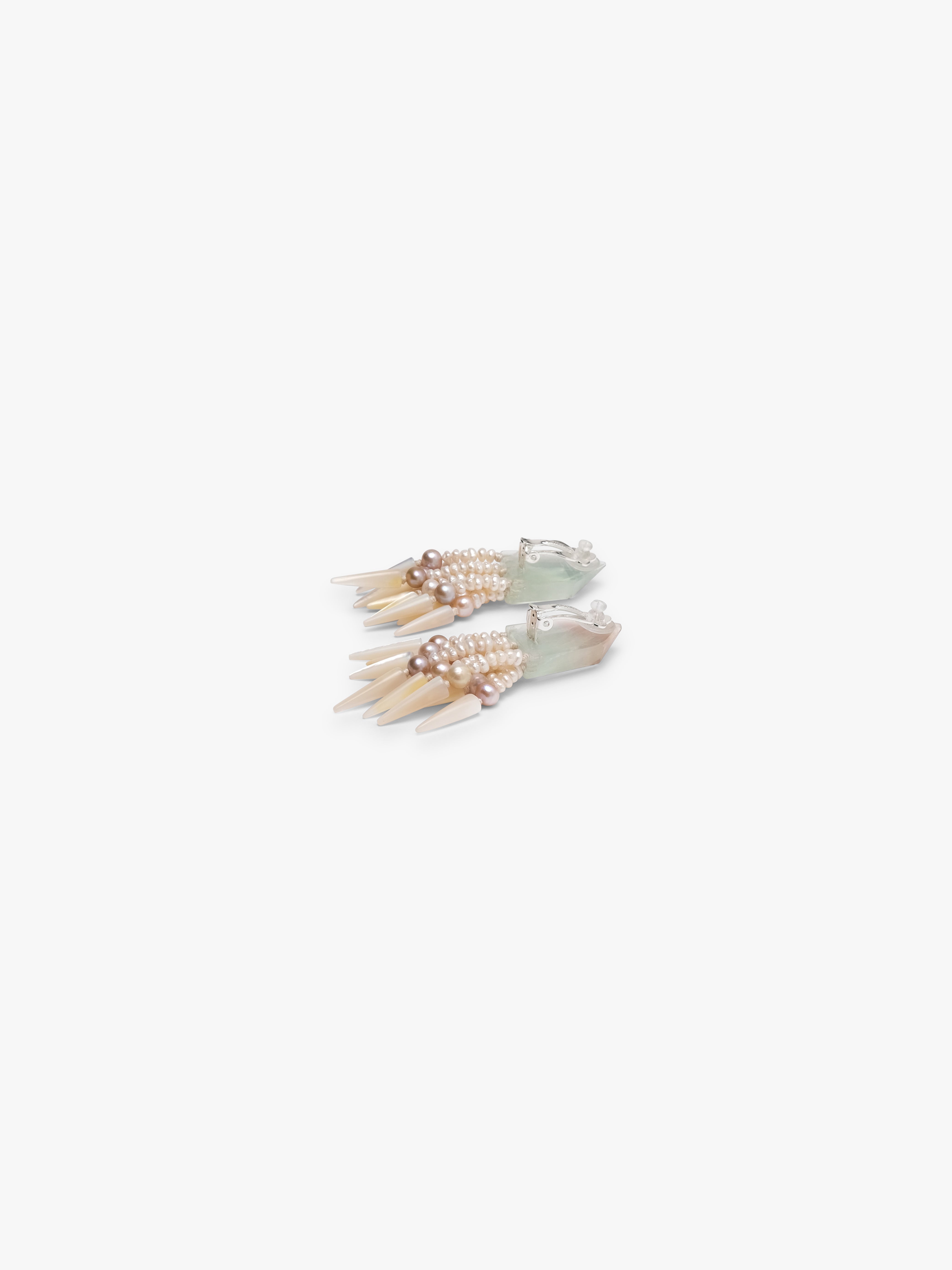 Pair of earrings with multiple strands on a white background