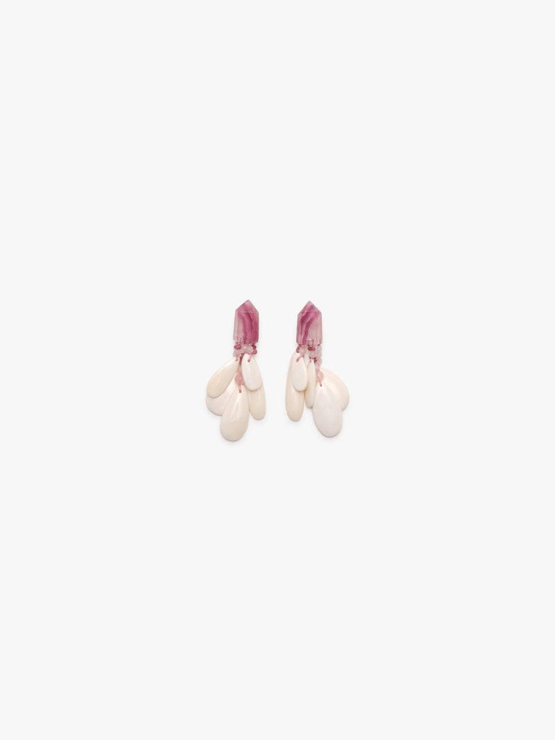Earrings with pink stones and bone on a white background