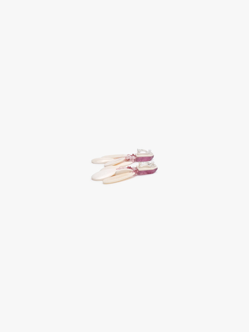 Earrings with pink stones and bone on a white background