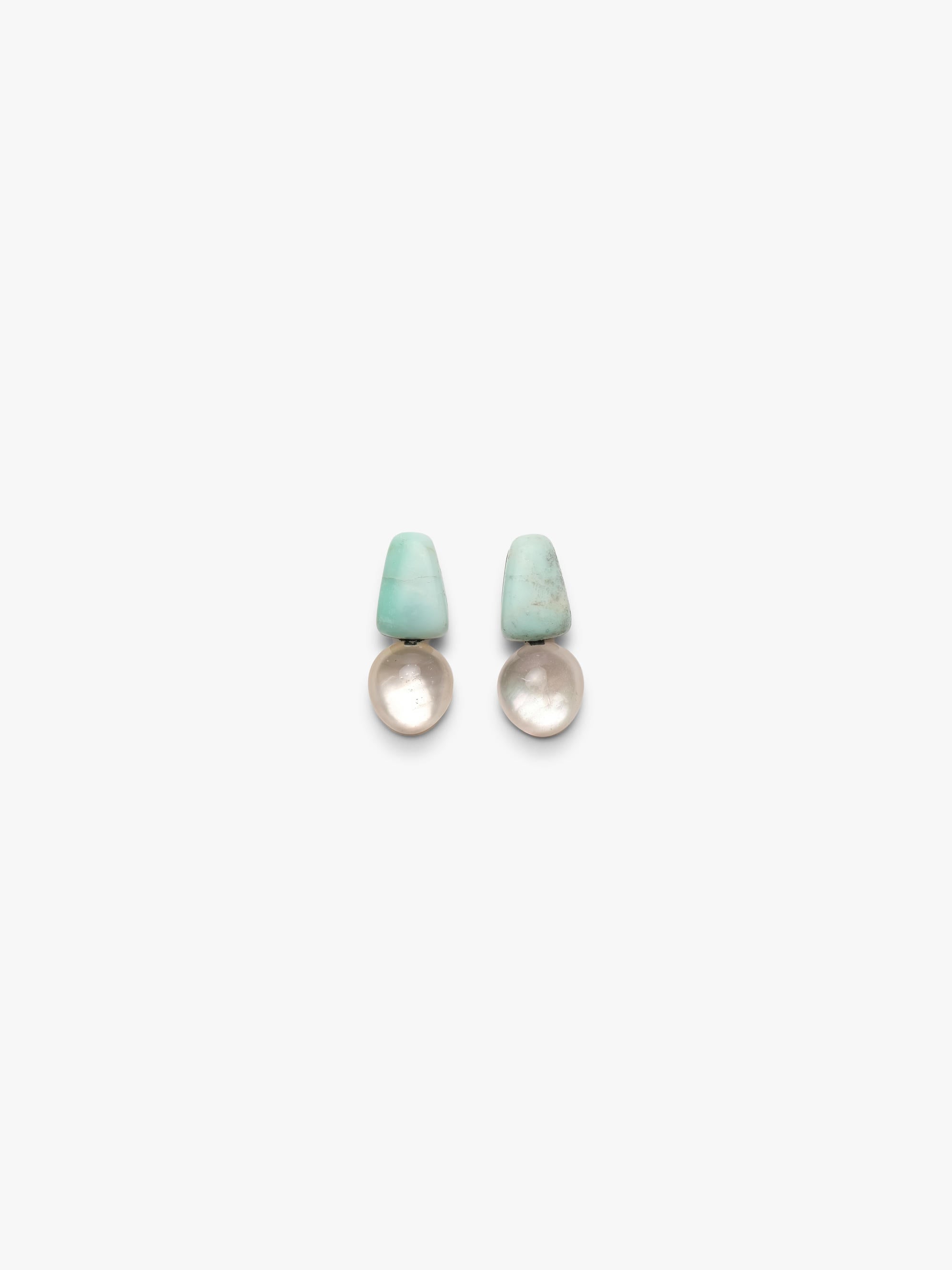 Pair of earrings with turquoise tops and crystal bases on a white background