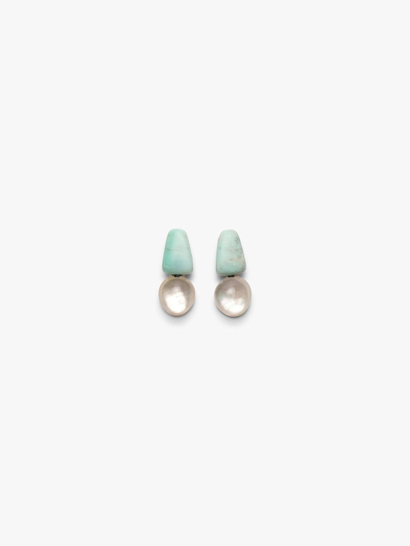 Pair of earrings with turquoise tops and crystal bases on a white background