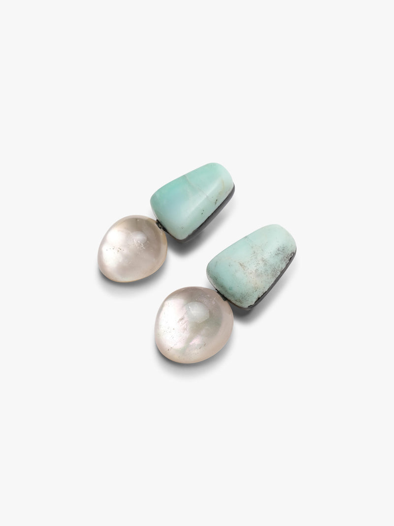Pair of earrings with turquoise tops and crystal bases on a white background